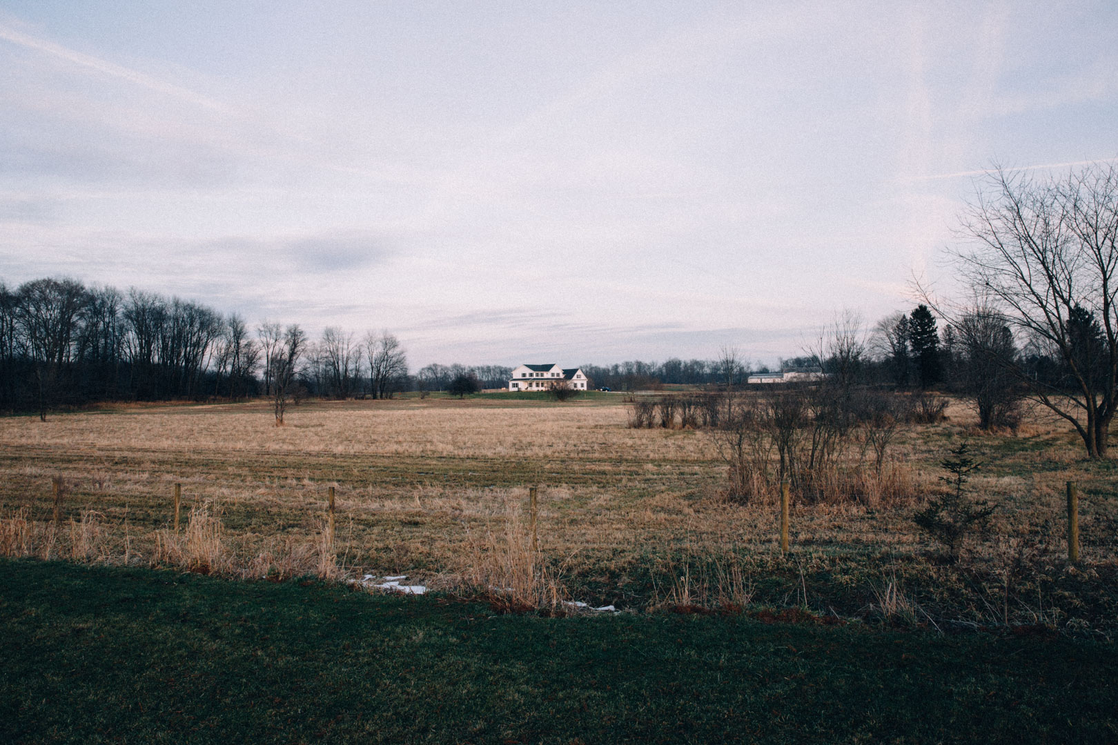 Schmader Farms property — the farmhouse across the pasture field in late autumn
